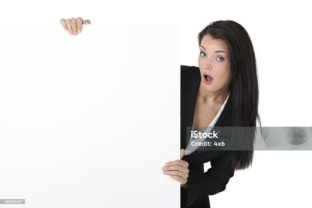 Businesswoman holding a placard and looking surprised 20-29 Years Stock Photo