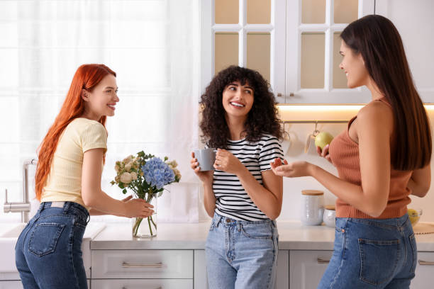 istock Happy young friends spending time together in kitchen 1868243729