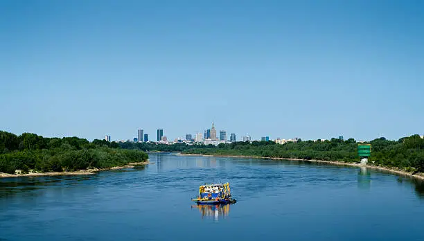 Warsaw skyline with boat in the foreground.