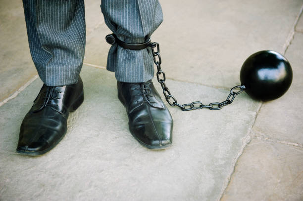 istock Ball and Chain Businessman Stands on Stone Background 186824570