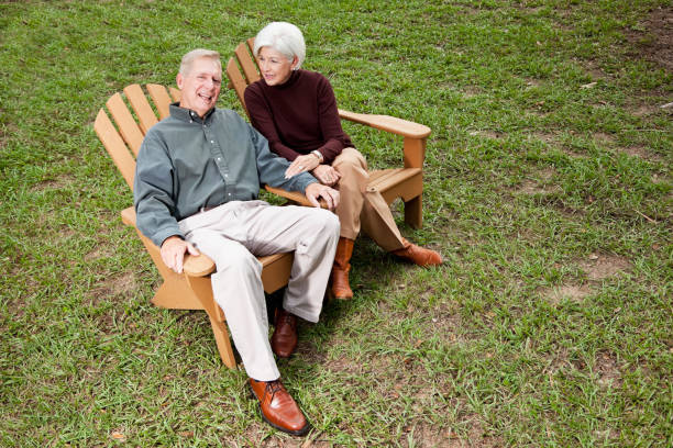 istock Senior couple sitting on adirondack chairs 186824659
