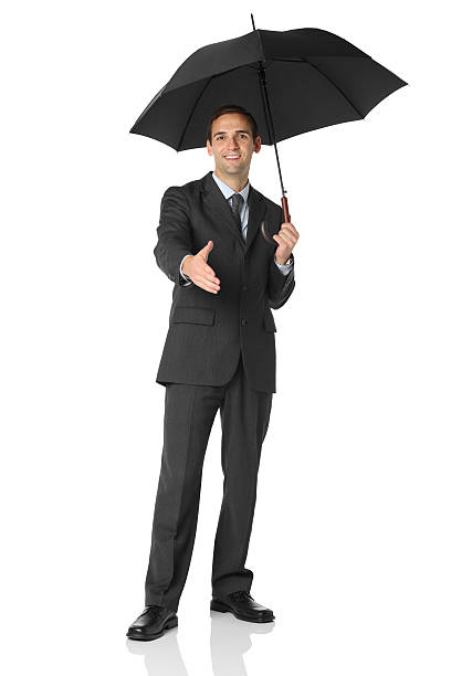 istock Businessman under an umbrella offering handshake 186826157
