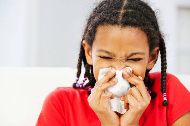 istock African American girl blowing her nose. 186826189
