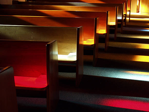 Church Benches at Sunset Shot these benches (or pews) at sunset after a friend's wedding rehearsal with an Olympus E-10 digital SLR. pew stock pictures, royalty-free photos & images