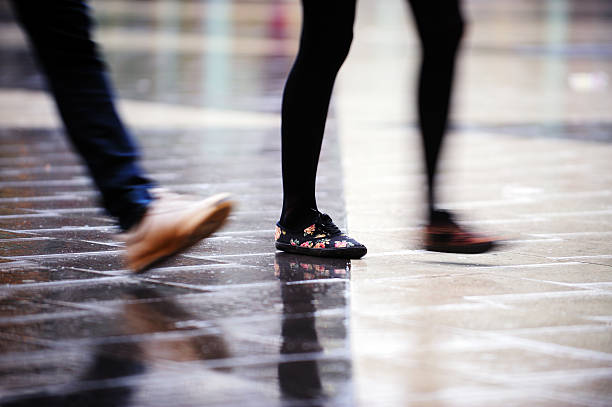 istock Motion blurred person crossing rain wet square 186827644