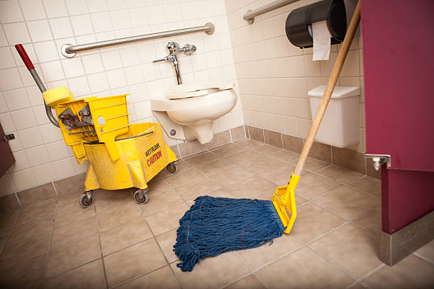 Mop and Bucket on Tile Floor in Restroom