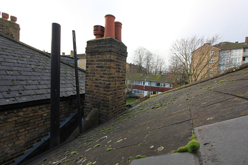 on a roof in Britain, is an old brick built chimney and cowlings