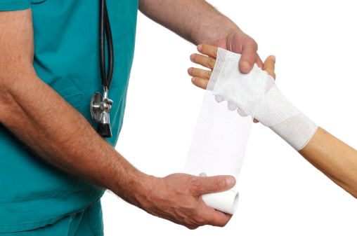 Doctor bandaging woman wrist