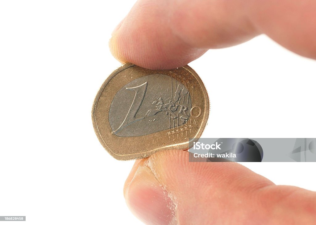 weakness of euro - schwacher verformte Euromünze Euro between human fingers. Symbolizes the softness of the currency Euro Symbol Stock Photo