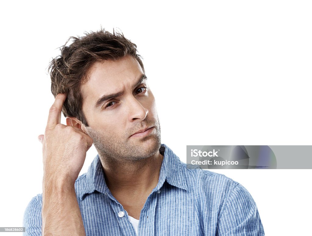 I've just got to find the solution Young and handsome man thinking while looking puzzled and isolated on white Adult Stock Photo