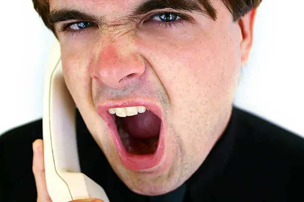 Angry man yelling into phone