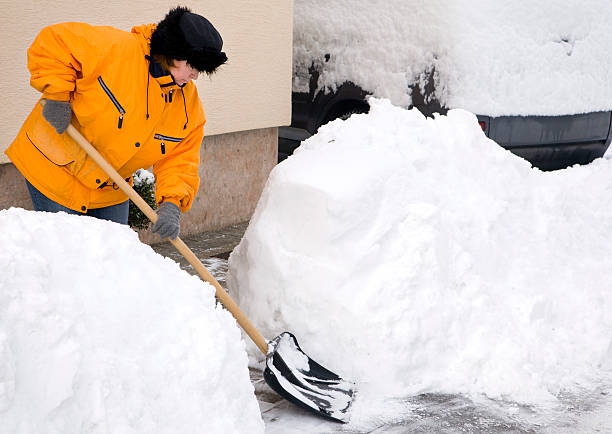 istock Woman shovelling driveway 186828885