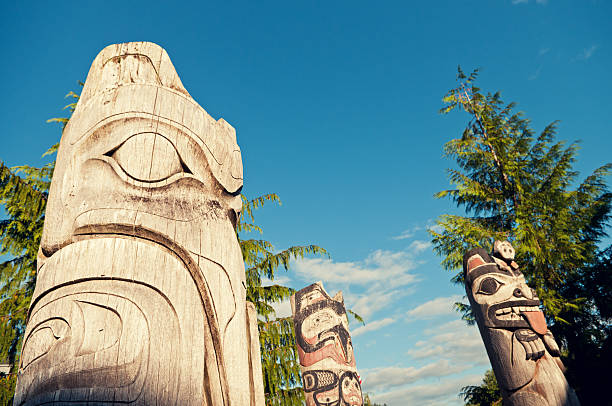 Totem Pole "Totem poles in afternoon sunlight.  Ketchikan, Alaska." southeastern alaska stock pictures, royalty-free photos & images