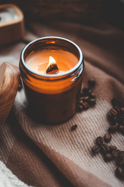 istock Burning candle and coffee beans, cozy photo 1868289661