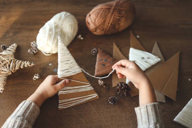 istock Child makes Christmas decoration from yarn 1868293842