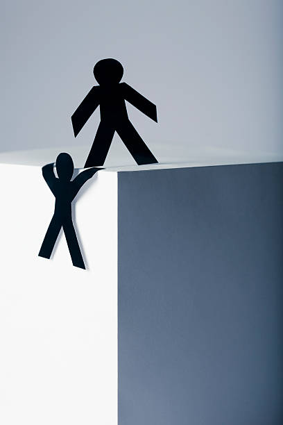istock Helping hand - paper people concept 186829626