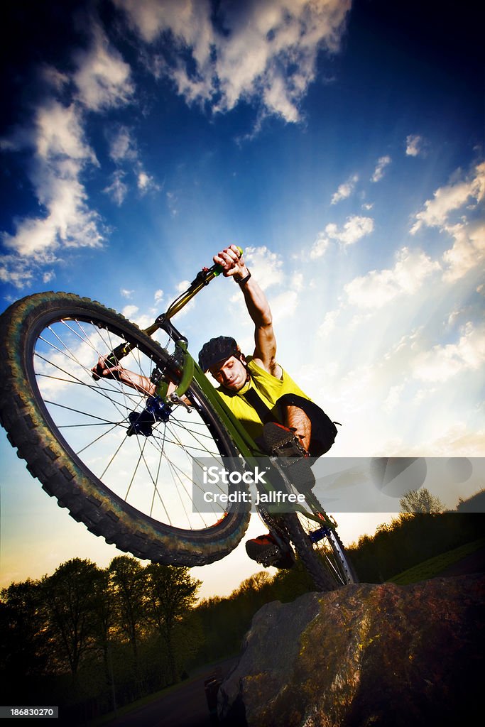 Extreme mountain biking jumping off a rock Bike Trials BMX Cycling Stock Photo