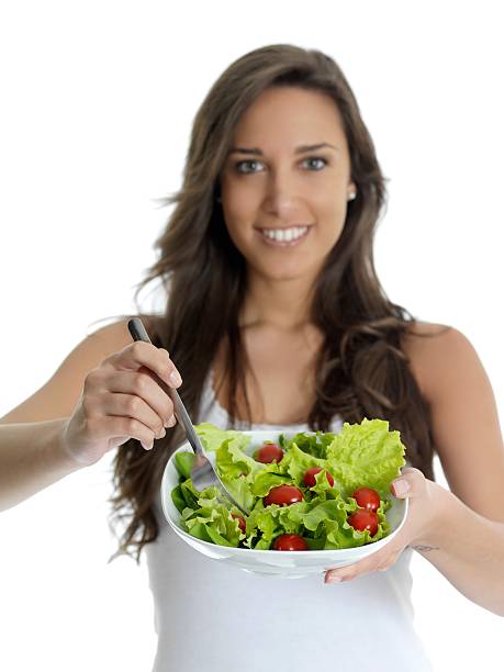 istock girl eating salad 186830465