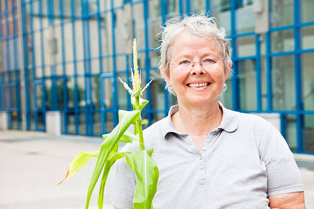 istock senior woman with plant 186830548