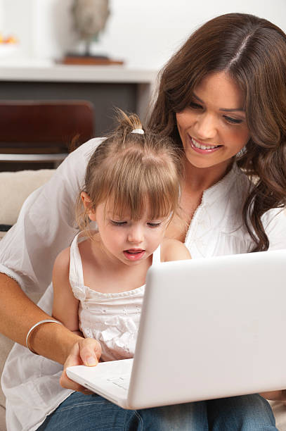 istock Little girl and her mother using a laptop 186830846