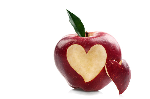 Red apple with heart shape isolated on white