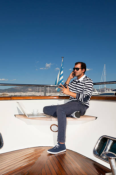 istock Yacht businessman working with laptop and discussing 186832081