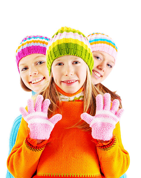 istock Three girls in colorful cardigans looking at the camera. 186832761