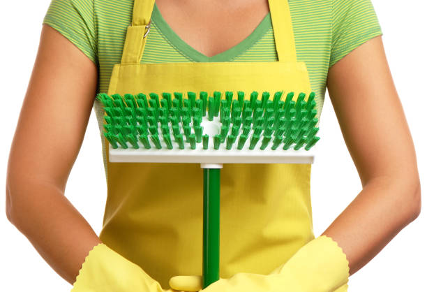 Maid holding a scrub brush 