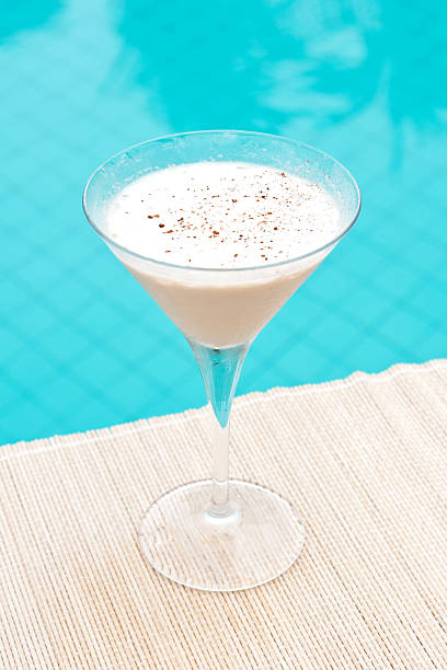 Classic Brandy Alexander cocktail near waterpool on the mat stock photo