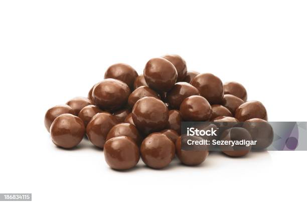 Dipped Chocolate Peanuts In A Pile On A White Background Stock Photo - Download Image Now