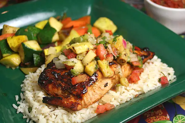 Salmon filet topped with grilled pineapple salsa and served with white rice and calabacita vegetables. Please see my portfolio for many more food photos.