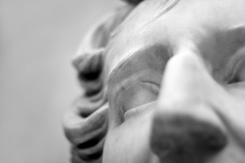 close up of a head of a classical stone statue. shallow DOF