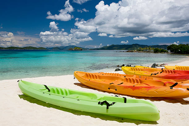 colorful kayaks on a beach in the Virgin Islands colorful kayaks on a beautiful beach in Sapphire Bay, St. Thomas, US Virgin Islands st. thomas virgin islands photos stock pictures, royalty-free photos & images