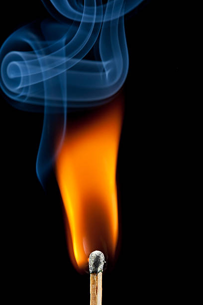 istock Ignition of match, with smoke on black 186834914