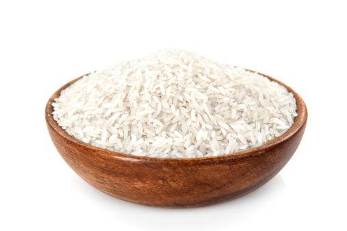 Rice in a wooden bowl on white background