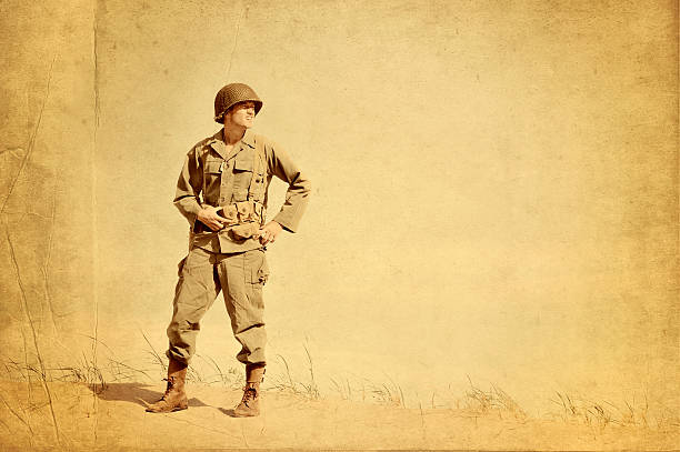 Faded Picture of World War II American Infantryman Faded picture of World War II American Infantryman standing on a lonely beach.  Gazing across to right of image as if to scan the horizon.  us military photos stock pictures, royalty-free photos & images
