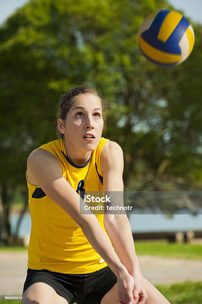 Volleyball defensive action Front view of young female volleyball player defending Volleyball - Ball Stock Photo