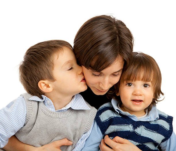istock Mother snuggling with her children 186836739