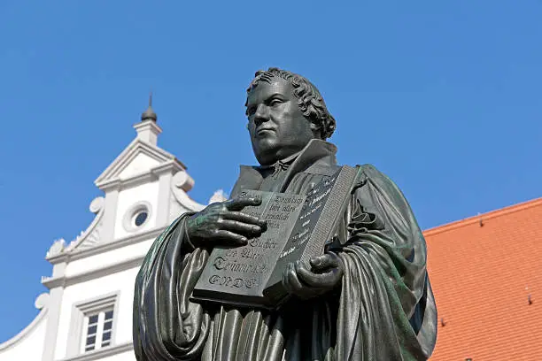 "Monument of Martin Luther. It was the first public monument of the great reformer, designed 1821 by Johann Gottfried Schadow. Martin Luther (1483-1546) was a German monk, theologian, and church reformer and the translator of the bible into German. He is also considered to be the founder of Protestantism. He lived and worked many years in Wittenberg."
