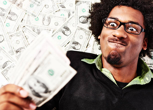 istock Zany young geek with many dollars makes triumphant face 186837067