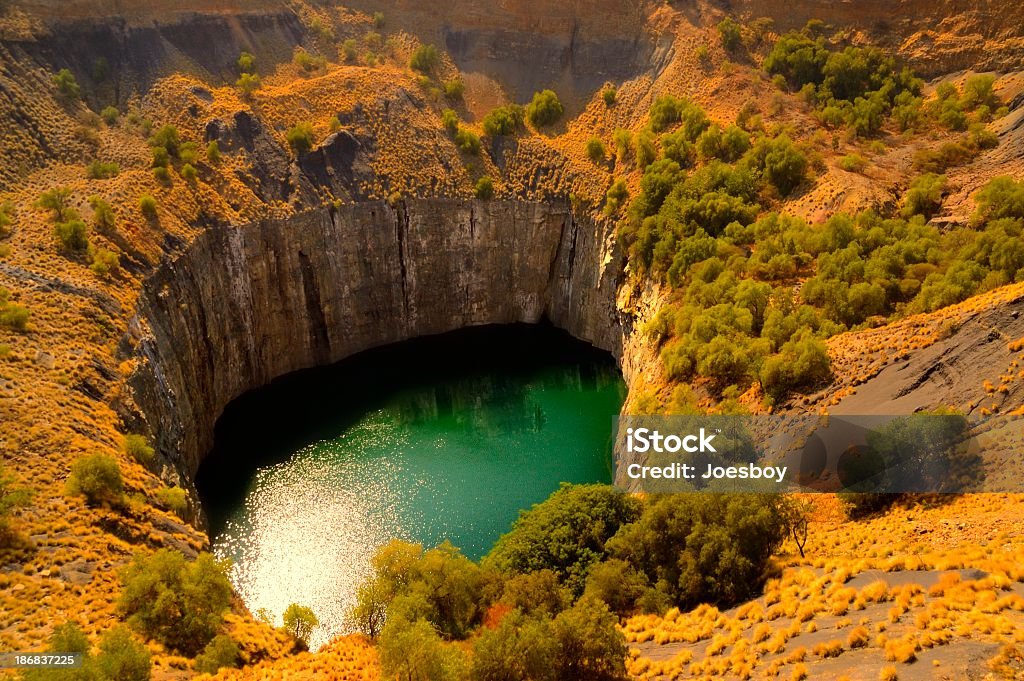 Aerial view of the Big Hole at the Kimberley Diamond Mine "This  is the famous Big Hole that provided access to the Kimberley Diamond mine, The water is 40m deep and the wall is 175m deep and other than that its just another hole in the ground but the morning light made it more interesting to me" South Africa Stock Photo