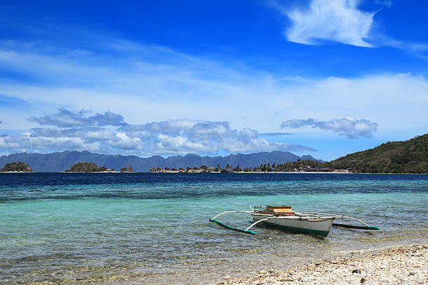 istock Outrigger fishing boat stranded at exotic beach 186837650