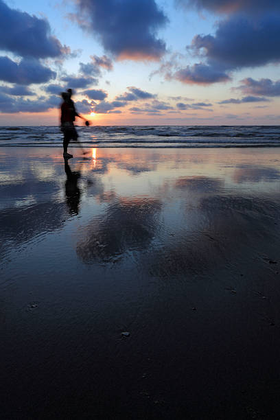 istock colourful sunset over a couple walking along the coastline 186837829