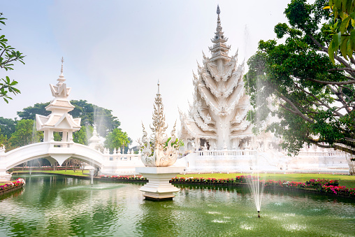 Intricately designed works of art,pagodas,pathways,water features and gardens,major tourist destination. Beautiful snow white,ornate architecture,created by master artist Chalermchai Kositpipat.