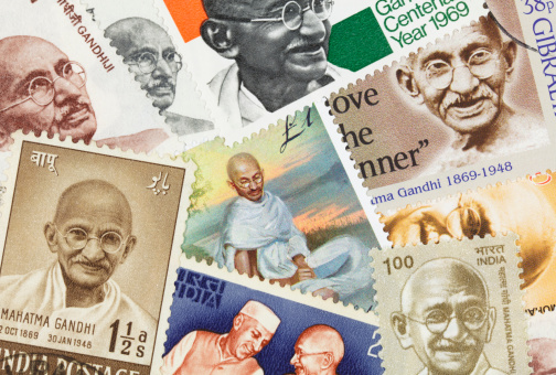 An assortment of postage stamps with images of Mahatma Gandhi.