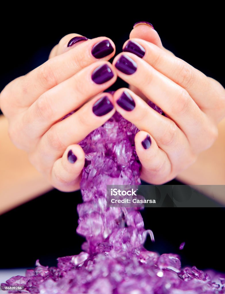 Woman's hands Beautiful woman's hands dropping stonesMore manicure related images: Adult Stock Photo