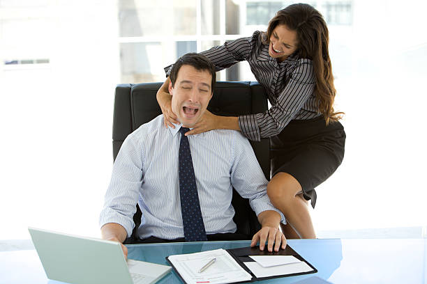 Business Strangler White collar female strangling white collar male at workplace. woman strangles man stock pictures, royalty-free photos & images