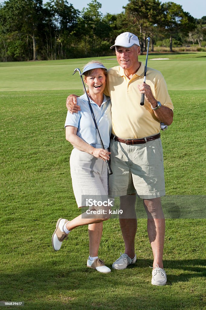 Senior couple playing golf Senior couple, 60s, on the golf course. 60-69 Years Stock Photo