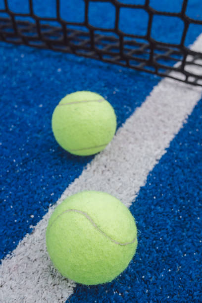 istock two balls in a blue paddle tennis court 1868405361