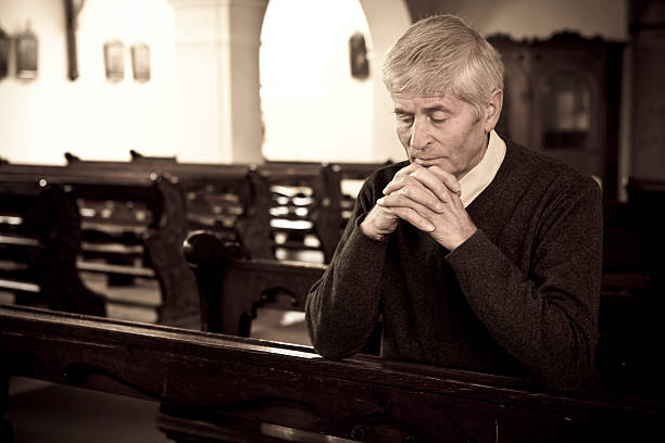 istock Praying man in church 186840541